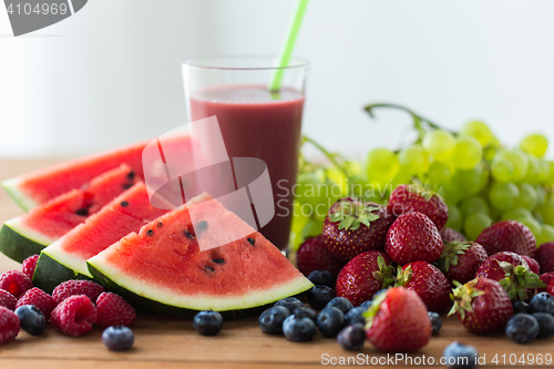 Image of fruit and berry juice or smoothie on wooden  table