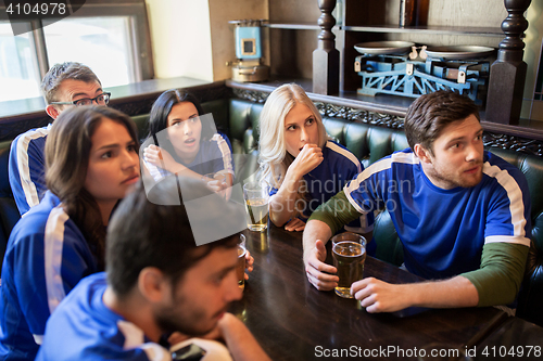 Image of fans or friends watching football at sport bar