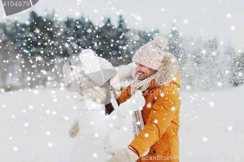 Image of happy couple hugging and laughing in winter