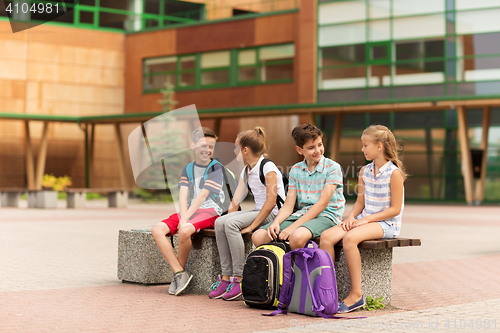 Image of group of happy elementary school students talking