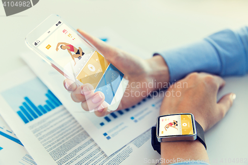 Image of close up of hands with smart phone and watch