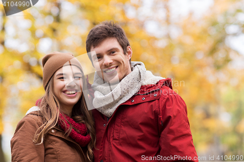 Image of happy young couple walking in autumn park