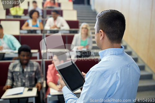 Image of teacher with tablet pc and students at lecture