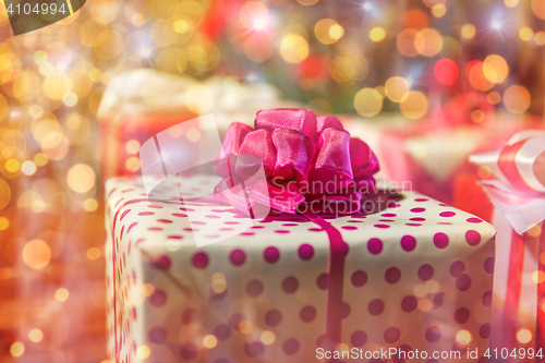 Image of close up of gift boxes over christmas tree lights