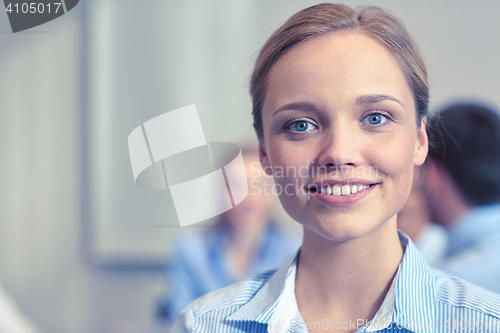 Image of group of smiling businesspeople meeting in office