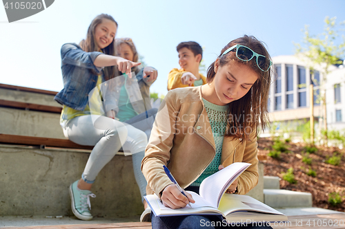 Image of student girl suffering of classmates mockery