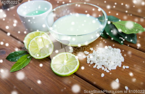 Image of body lotion, cream and salt on wood