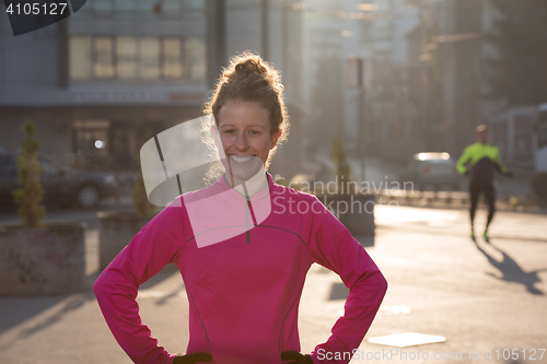 Image of woman  stretching before morning jogging