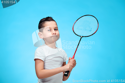 Image of The boy with badminton rackets outdoors