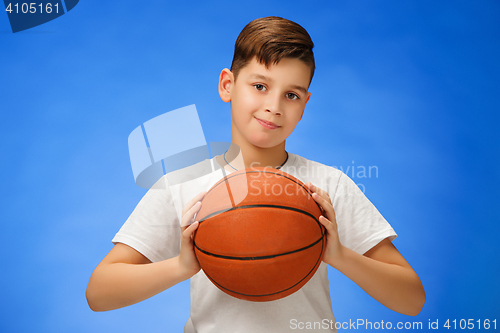 Image of Adorable 11 year old boy child with basketball ball