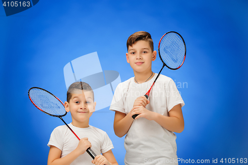 Image of The two boys with badminton rackets outdoors