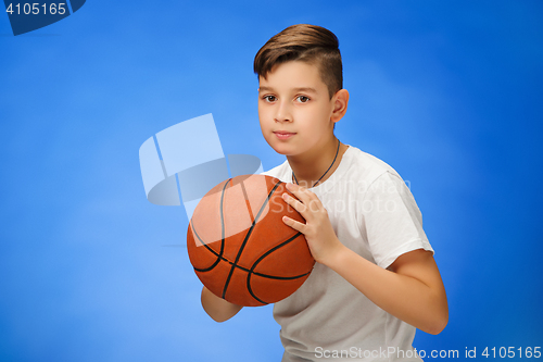 Image of Adorable 11 year old boy child with basketball ball