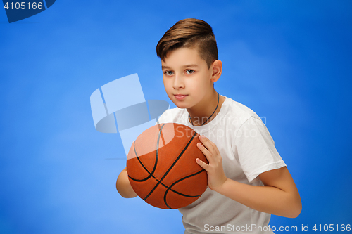 Image of Adorable 11 year old boy child with basketball ball