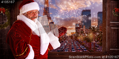 Image of The man in costume of santa claus over night city background