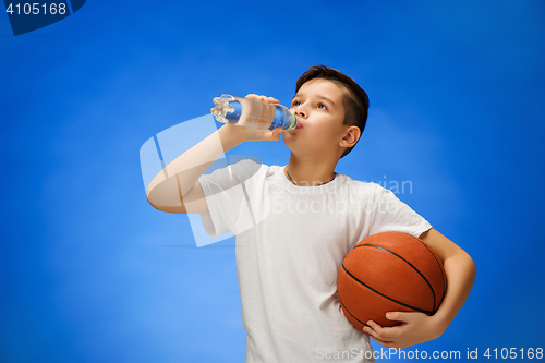 Image of Adorable 11 year old boy child with basketball ball