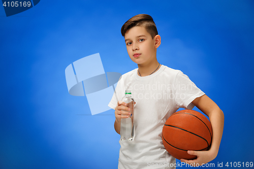 Image of Adorable 11 year old boy child with basketball ball