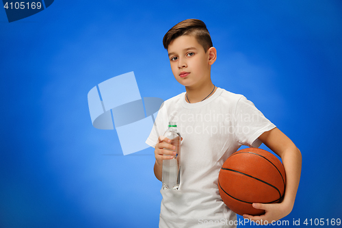 Image of Adorable 11 year old boy child with basketball ball