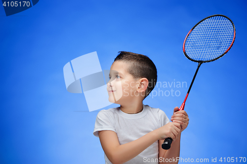 Image of The boy with badminton rackets outdoors