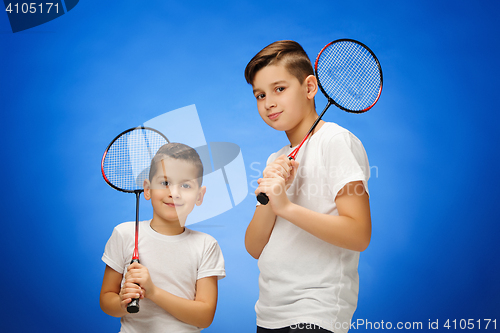 Image of The two boys with badminton rackets outdoors