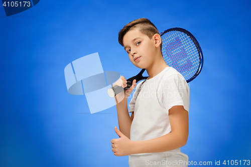Image of Young tennis player on blue background.
