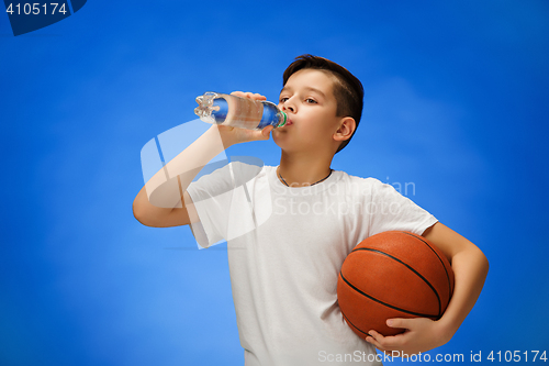 Image of Adorable 11 year old boy child with basketball ball