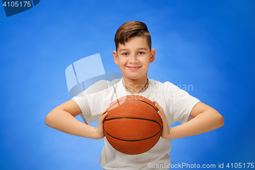 Image of Adorable 11 year old boy child with basketball ball