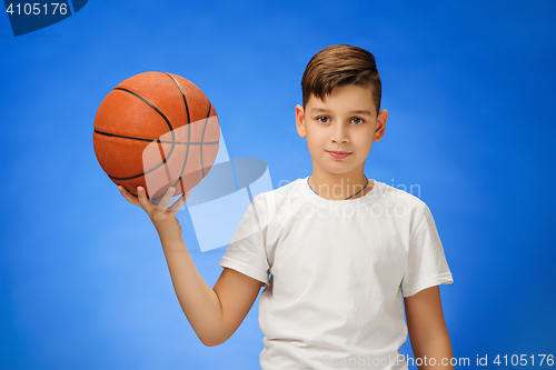 Image of Adorable 11 year old boy child with basketball ball