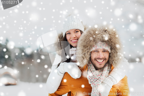 Image of happy couple having fun over winter background