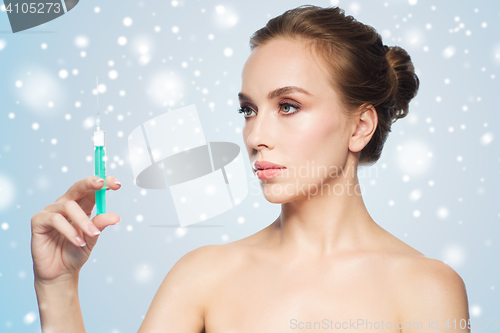 Image of beautiful woman holding syringe with injection