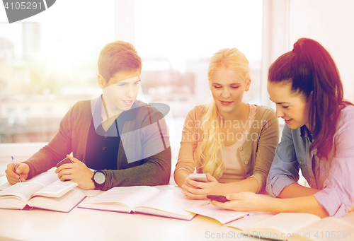 Image of smiling students with notebooks at school