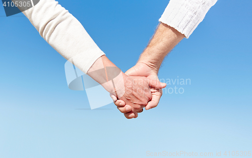 Image of close up of senior couple holding hands