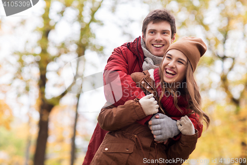 Image of happy young couple hugging in autumn park