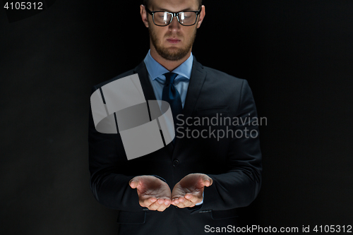 Image of close up of businessman holding something in hands