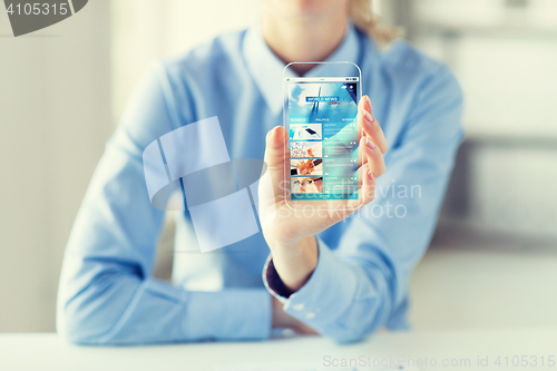 Image of close up of woman with world news on smartphone