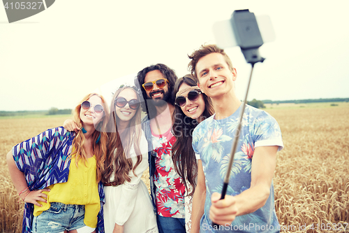 Image of hippie friends with smartphone on selfie stick