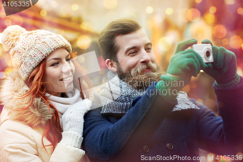 Image of couple taking selfie with smartphone in old town