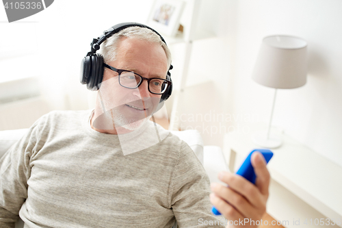 Image of happy senior man with smartphone and headphones