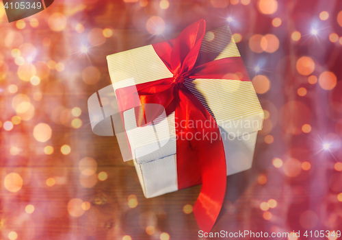 Image of close up of christmas gift box on wooden floor