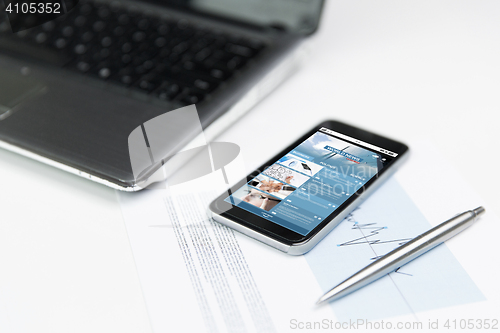 Image of close up of smartphone with business news page