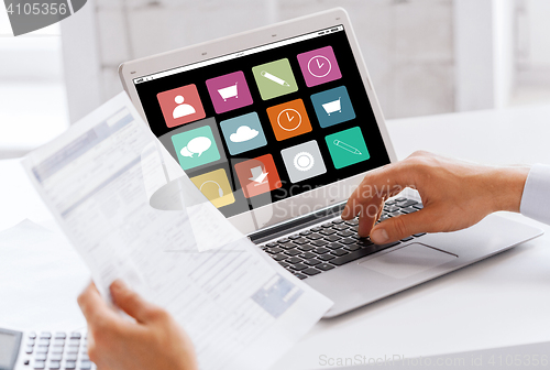 Image of businessman with laptop computer working at office