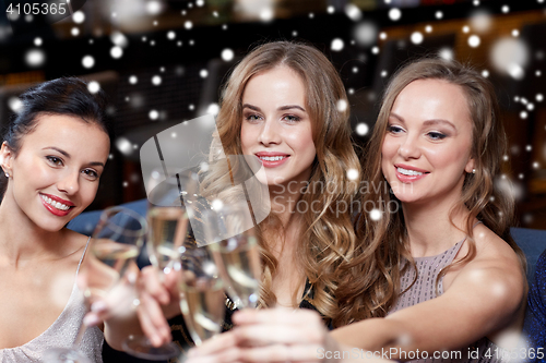 Image of happy women with champagne glasses at night club