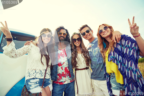 Image of hippie friends over minivan car showing peace sign