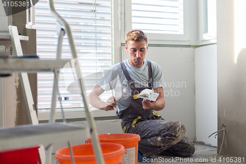 Image of Plasterer renovating indoor walls and ceilings. Finishing works.