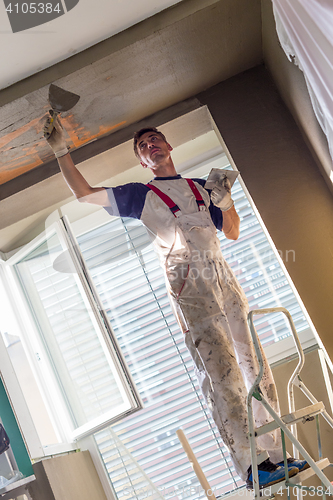 Image of Plasterer renovating indoor walls and ceilings. Finishing works.