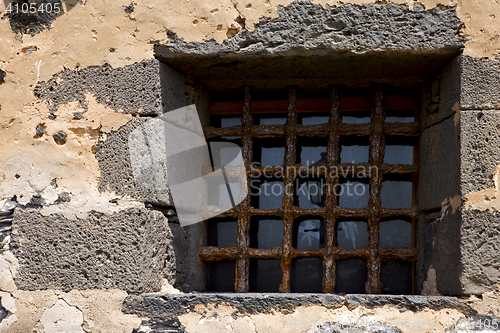 Image of brown distorted  castle window in a broke   wall arrecife  