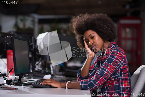 Image of a young African American woman feels tired in the modern office