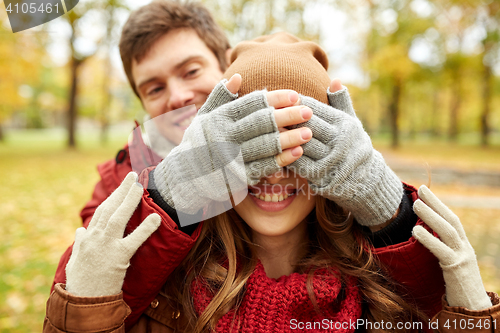 Image of happy young couple having fun in autumn park