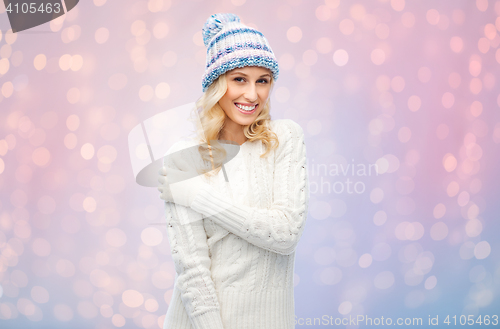 Image of smiling young woman in winter hat and sweater