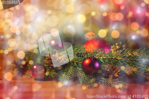 Image of fir branch with christmas ball and pinecones