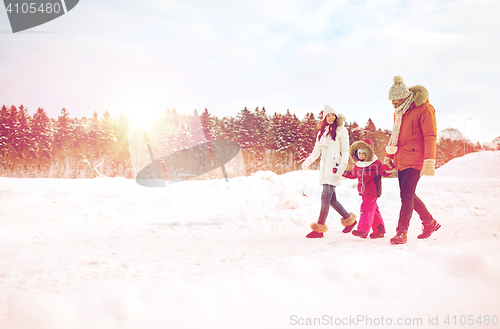 Image of happy family in winter clothes walking outdoors